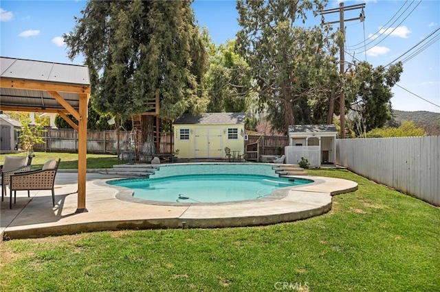 view of pool with an outdoor structure, a fenced backyard, a shed, and a yard
