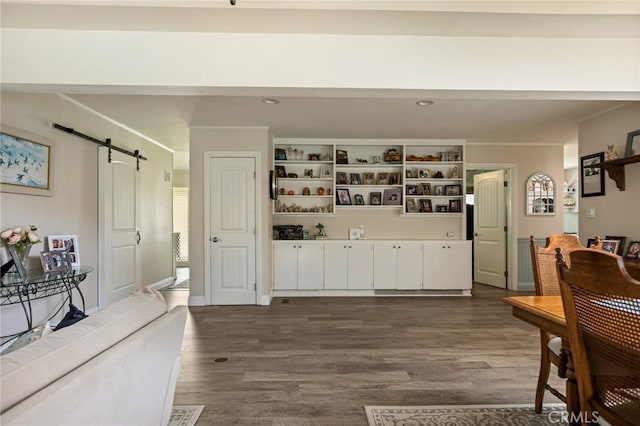 interior space with white cabinetry, open shelves, dark wood finished floors, and a barn door