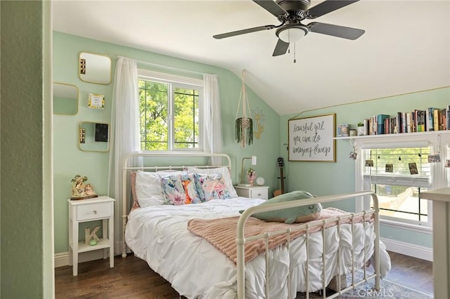 bedroom with ceiling fan, baseboards, vaulted ceiling, and wood finished floors