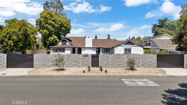 17441 Rayen St, Sherwood Forest, CA 91325 - ranch-style home featuring stone siding, stucco siding, a chimney, a gate, and a fenced front yard