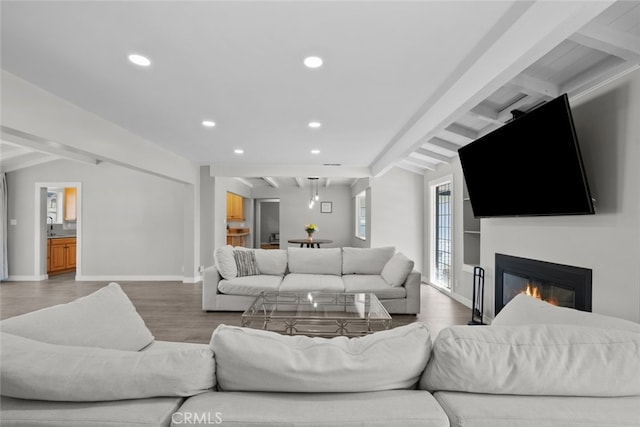 17441 Rayen St, Sherwood Forest, CA 91325 - living room with beam ceiling, wood finished floors, baseboards, a glass covered fireplace, and recessed lighting