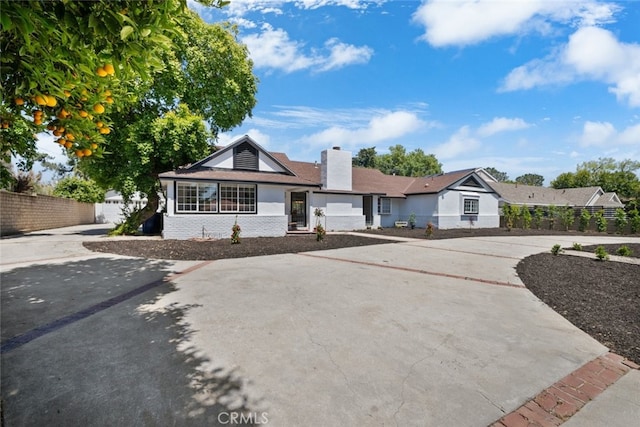 17441 Rayen St, Sherwood Forest, CA 91325 - view of front of property with concrete driveway, brick siding, fence, and a chimney