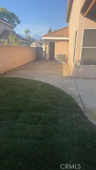 view of yard featuring fence and a patio