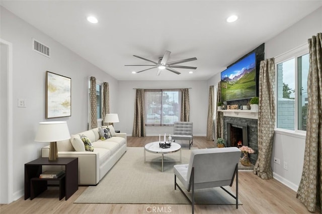 18012 Falda Ave, Torrance, CA 90504 - living area featuring visible vents, a ceiling fan, a wealth of natural light, and a stone fireplace