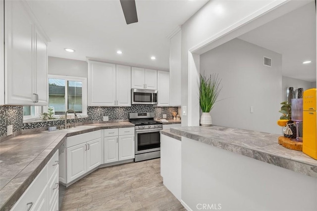 18012 Falda Ave, Torrance, CA 90504 - kitchen featuring a sink, white cabinetry, and appliances with stainless steel finishes