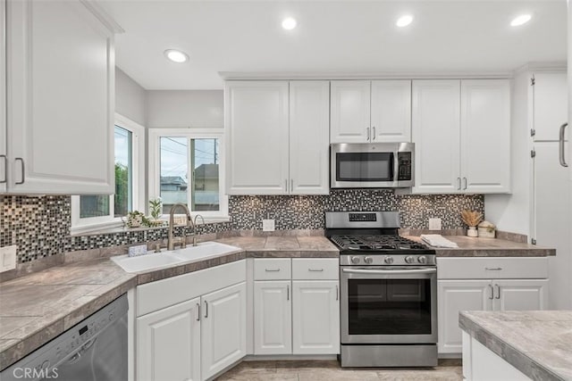 18012 Falda Ave, Torrance, CA 90504 - kitchen with stainless steel appliances, white cabinets, tasteful backsplash, recessed lighting, and tile countertops