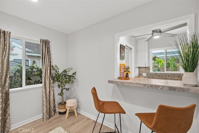 18012 Falda Ave, Torrance, CA 90504 - kitchen with a breakfast bar, light wood finished floors, healthy amount of natural light, and backsplash