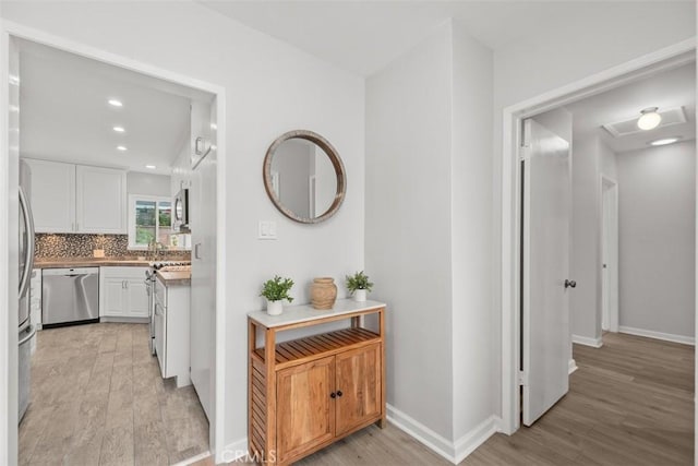 18012 Falda Ave, Torrance, CA 90504 - hallway featuring recessed lighting, baseboards, and light wood-style floors