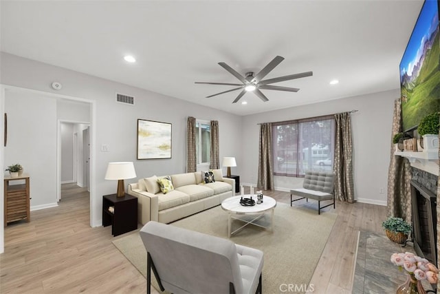 18012 Falda Ave, Torrance, CA 90504 - living room with a ceiling fan, visible vents, baseboards, a fireplace with raised hearth, and light wood-style flooring