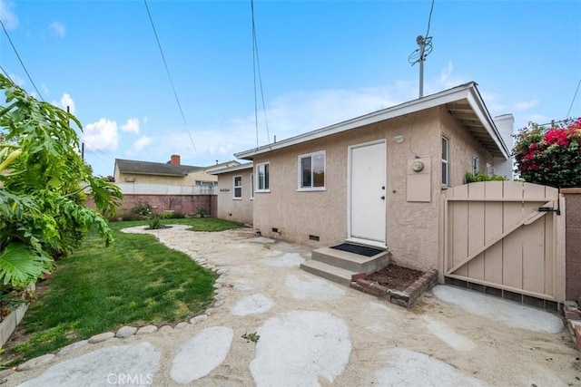 18012 Falda Ave, Torrance, CA 90504 - rear view of house with crawl space, a lawn, a fenced backyard, entry steps, and stucco siding
