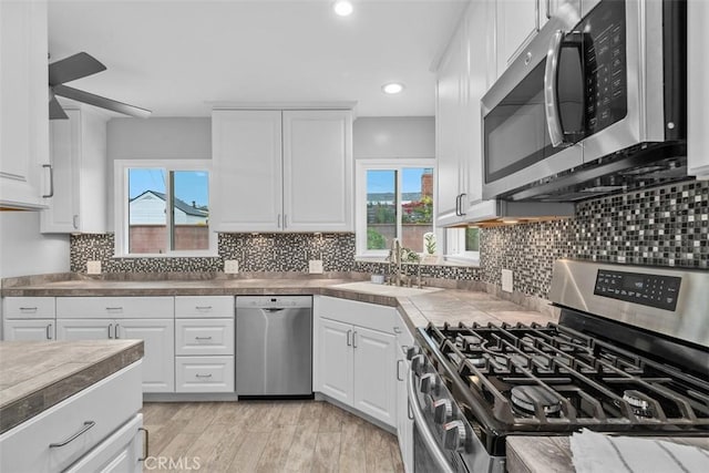 18012 Falda Ave, Torrance, CA 90504 - kitchen with a sink, white cabinets, stainless steel appliances, and a wealth of natural light
