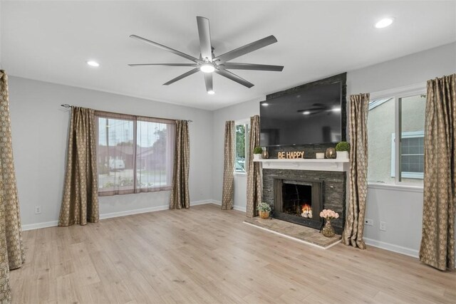 18012 Falda Ave, Torrance, CA 90504 - unfurnished living room featuring ceiling fan, a stone fireplace, healthy amount of natural light, wood finished floors, and recessed lighting