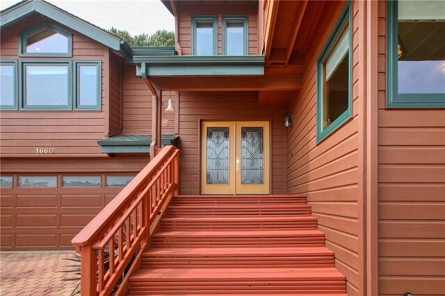 1660 Saint Thomas Ave, Cambria, CA 93428 - doorway to property featuring a garage, french doors, and decorative driveway