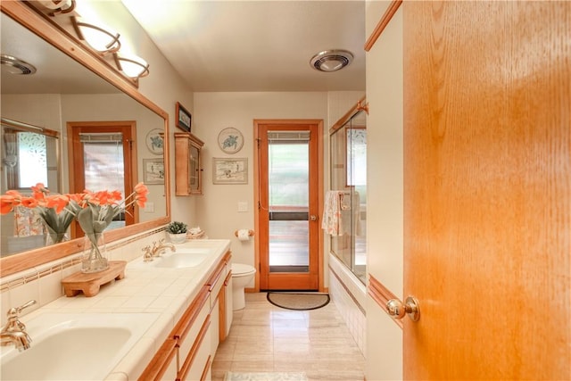 1660 Saint Thomas Ave, Cambria, CA 93428 - bathroom featuring toilet, double vanity, and shower / bath combination with glass door