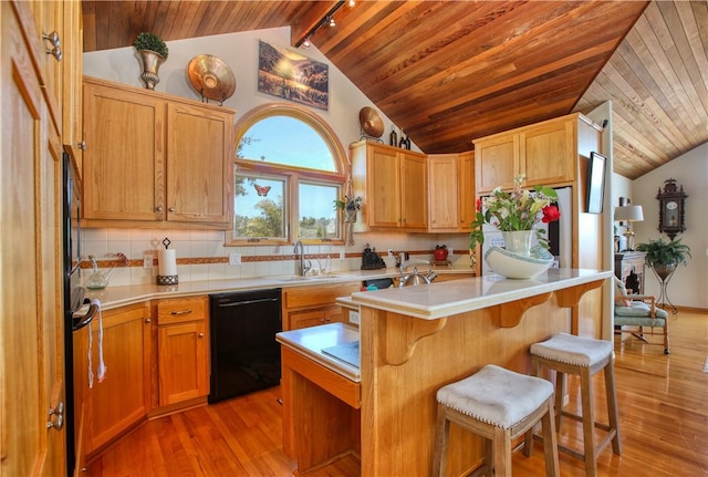 1660 Saint Thomas Ave, Cambria, CA 93428 - kitchen with black appliances, a sink, wooden ceiling, a kitchen breakfast bar, and light wood finished floors