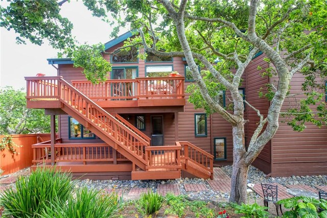 1660 Saint Thomas Ave, Cambria, CA 93428 - rear view of house with a wooden deck, stairway, and fence