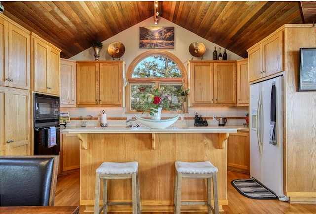 1660 Saint Thomas Ave, Cambria, CA 93428 - kitchen featuring black appliances, vaulted ceiling, light countertops, wood ceiling, and tasteful backsplash