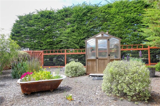 1660 Saint Thomas Ave, Cambria, CA 93428 - view of greenhouse with fence and a garden