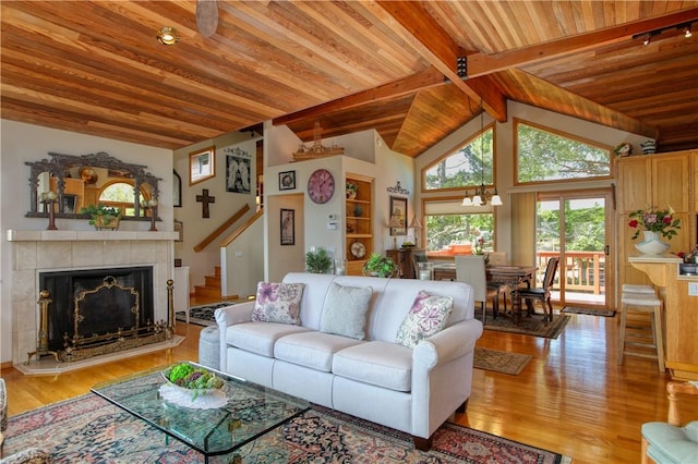 1660 Saint Thomas Ave, Cambria, CA 93428 - living area with wooden ceiling, wood finished floors, stairway, a tile fireplace, and a chandelier