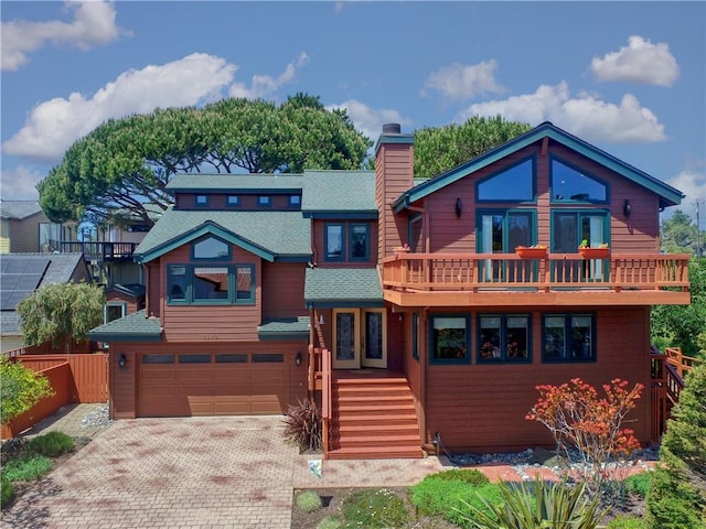 1660 Saint Thomas Ave, Cambria, CA 93428 - chalet / cabin with a balcony, a garage, a chimney, roof with shingles, and decorative driveway
