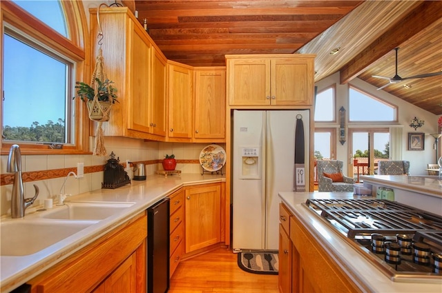 1660 Saint Thomas Ave, Cambria, CA 93428 - kitchen featuring white fridge with ice dispenser, gas stovetop, wood ceiling, a sink, and light wood-style flooring