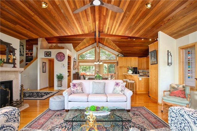 1660 Saint Thomas Ave, Cambria, CA 93428 - living area with wooden ceiling, ceiling fan, light wood-style flooring, and a tile fireplace