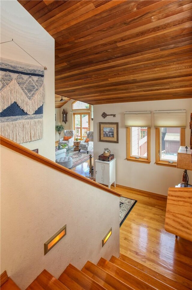 1660 Saint Thomas Ave, Cambria, CA 93428 - stairs featuring wooden ceiling, wood finished floors, vaulted ceiling, healthy amount of natural light, and baseboards