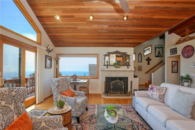 1660 Saint Thomas Ave, Cambria, CA 93428 - living room with wooden ceiling, vaulted ceiling, stairway, a tile fireplace, and wood finished floors