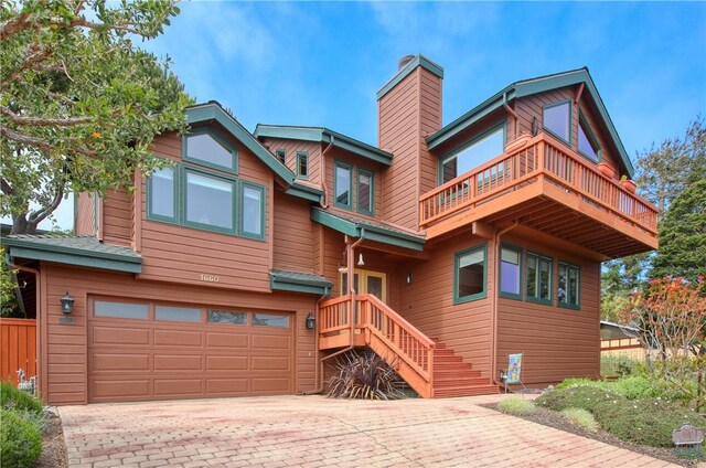 1660 Saint Thomas Ave, Cambria, CA 93428 - view of front of home featuring a garage, a balcony, a chimney, and decorative driveway