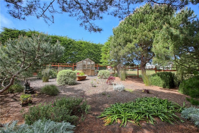 1660 Saint Thomas Ave, Cambria, CA 93428 - view of yard with a greenhouse, fence, and an outbuilding