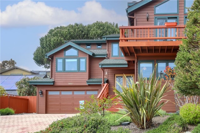 1660 Saint Thomas Ave, Cambria, CA 93428 - chalet / cabin featuring a balcony, a garage, fence, decorative driveway, and a shingled roof