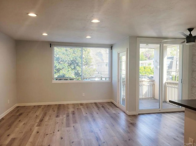 interior space with recessed lighting, baseboards, plenty of natural light, and wood finished floors