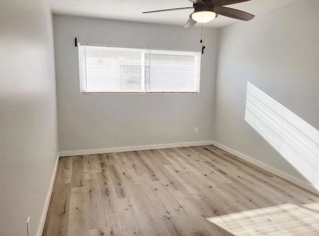 unfurnished room featuring a ceiling fan, baseboards, and wood finished floors