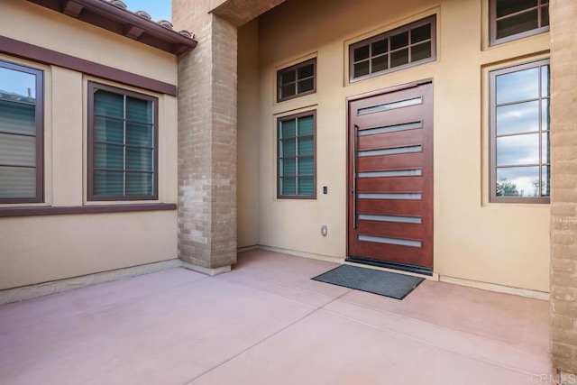 3881 Rancho Summit Dr, Encinitas, CA 92024 - property entrance with stucco siding and a patio