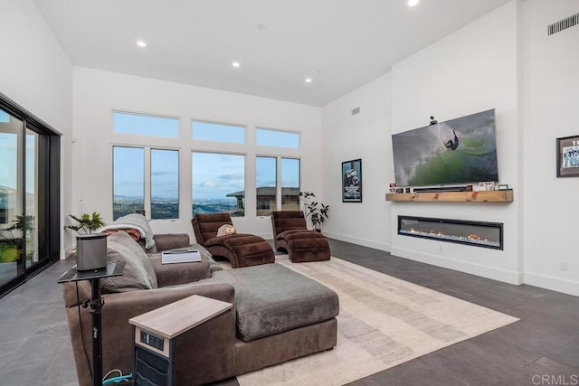 3881 Rancho Summit Dr, Encinitas, CA 92024 - living area featuring a high ceiling, recessed lighting, a glass covered fireplace, and baseboards