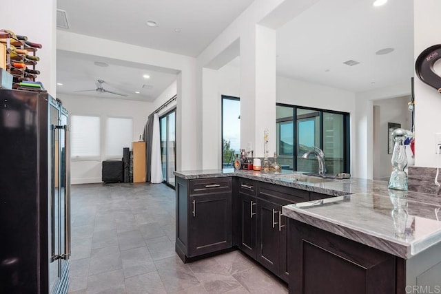 3881 Rancho Summit Dr, Encinitas, CA 92024 - kitchen with a sink, high end refrigerator, a peninsula, light stone countertops, and recessed lighting