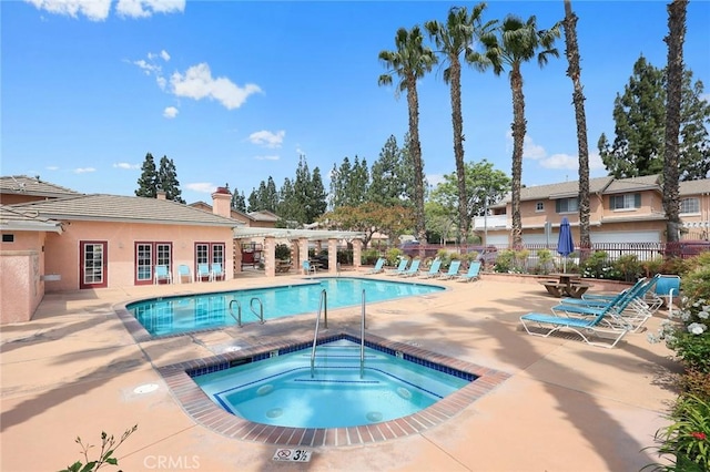 community pool featuring a pergola, fence, a community hot tub, and a patio area