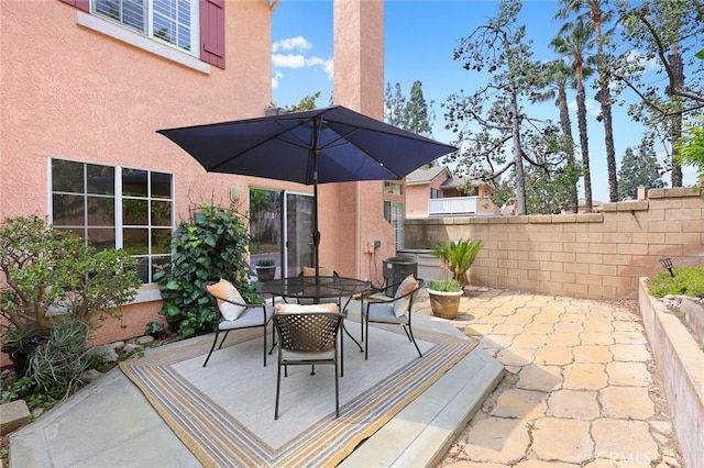 view of patio featuring fence and outdoor dining space