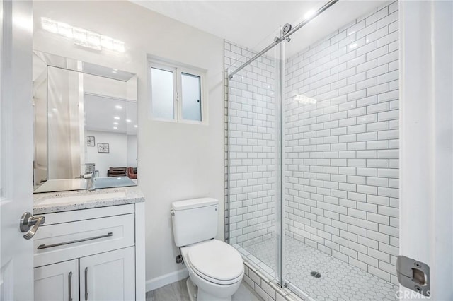 bathroom featuring vanity, toilet, and a stall shower