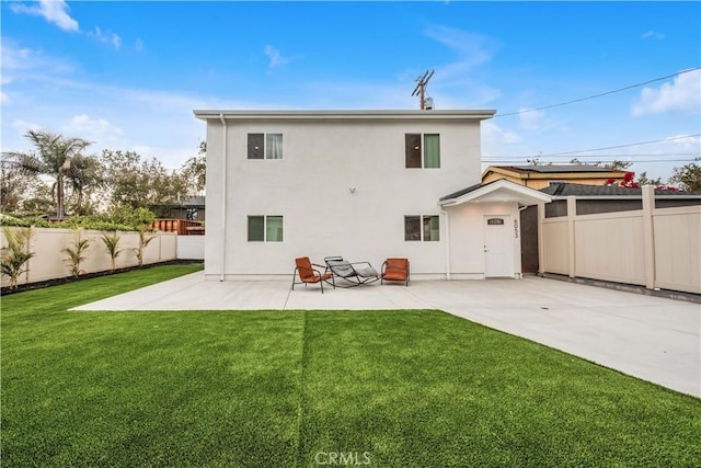 back of house featuring a patio, a fenced backyard, stucco siding, and a yard