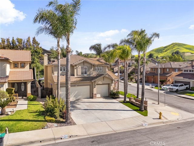 4677 Willow Bend Ct, Chino Hills, CA 91709 - traditional-style house featuring a residential view, a tile roof, a garage, stucco siding, and concrete driveway