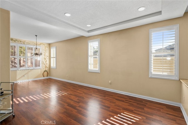 4677 Willow Bend Ct, Chino Hills, CA 91709 - unfurnished room featuring a textured ceiling, a chandelier, baseboards, wood finished floors, and a tray ceiling