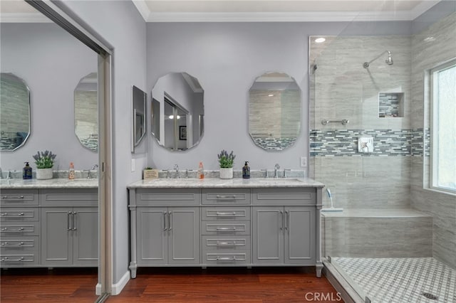 4677 Willow Bend Ct, Chino Hills, CA 91709 - full bathroom featuring double vanity, wood finished floors, a sink, ornamental molding, and tiled shower