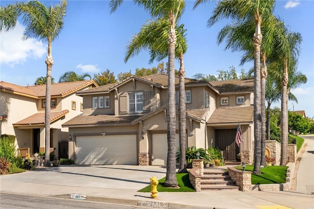 4677 Willow Bend Ct, Chino Hills, CA 91709 - view of front of home featuring stone siding, stucco siding, a tiled roof, an attached garage, and driveway