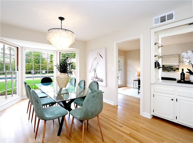dining area featuring visible vents, a healthy amount of sunlight, and light wood-type flooring