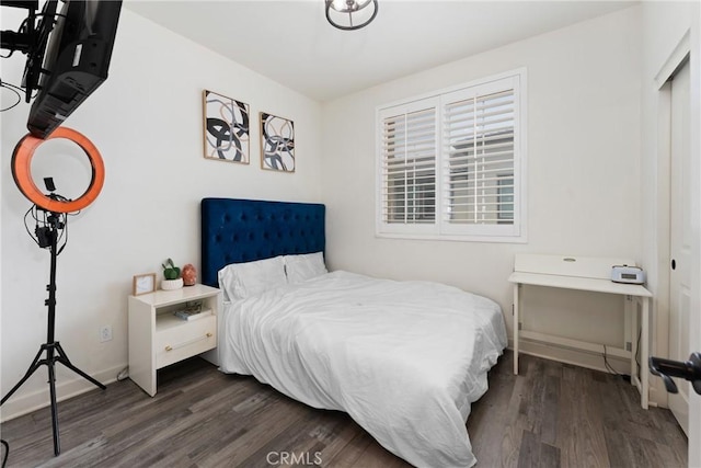 bedroom with baseboards and dark wood-style floors
