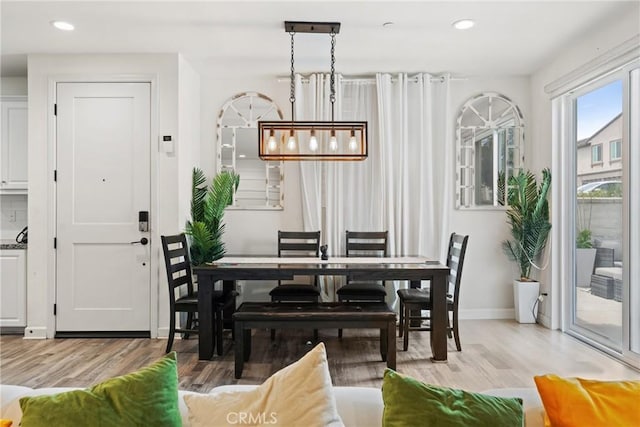 dining area featuring recessed lighting, baseboards, and light wood finished floors