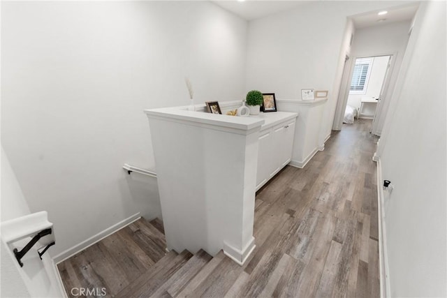 bathroom with baseboards, recessed lighting, and wood finished floors