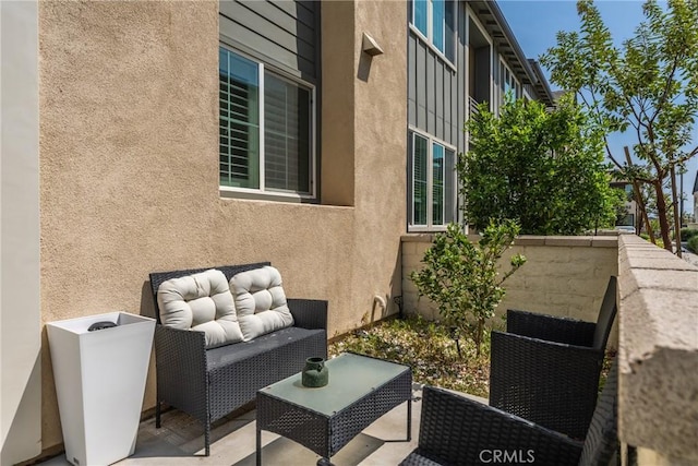 view of side of home with an outdoor hangout area, a patio area, and stucco siding