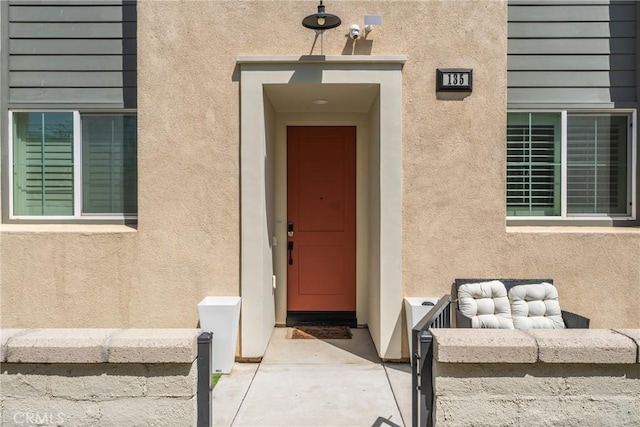 property entrance featuring stucco siding